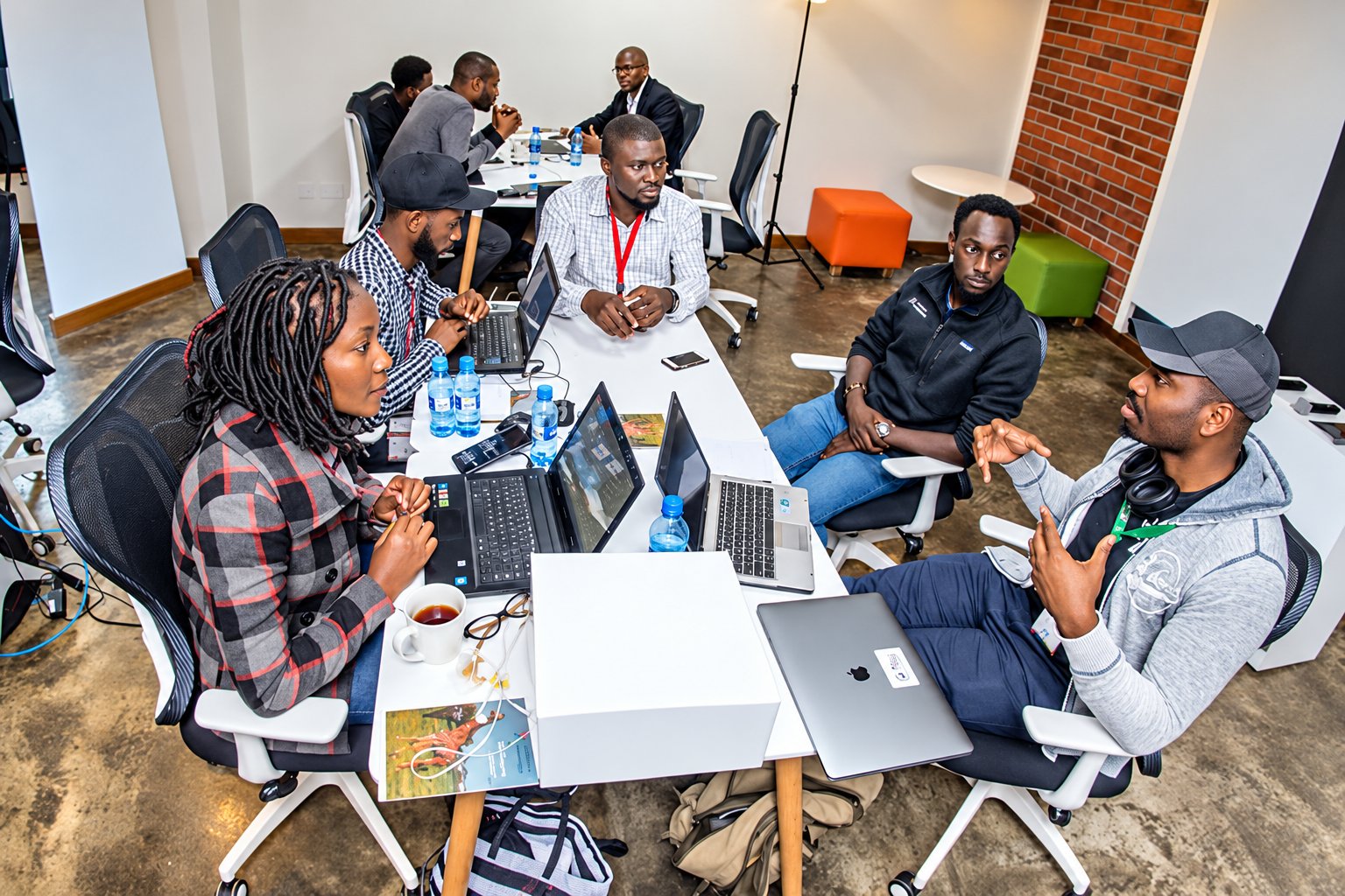 African startup entrepreneurs collaborating around a table in a technology workspace